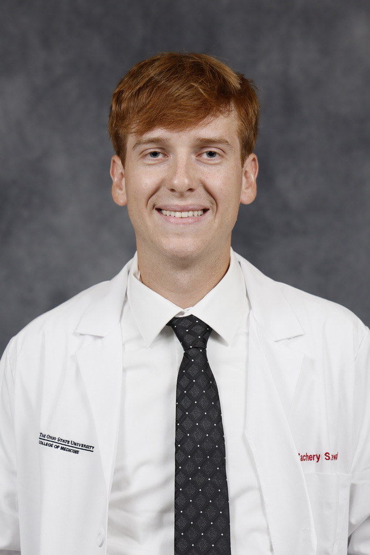 Zach Lewald in his medical school white coat