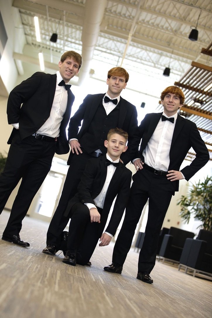 Zach with his brothers at a formal celebration